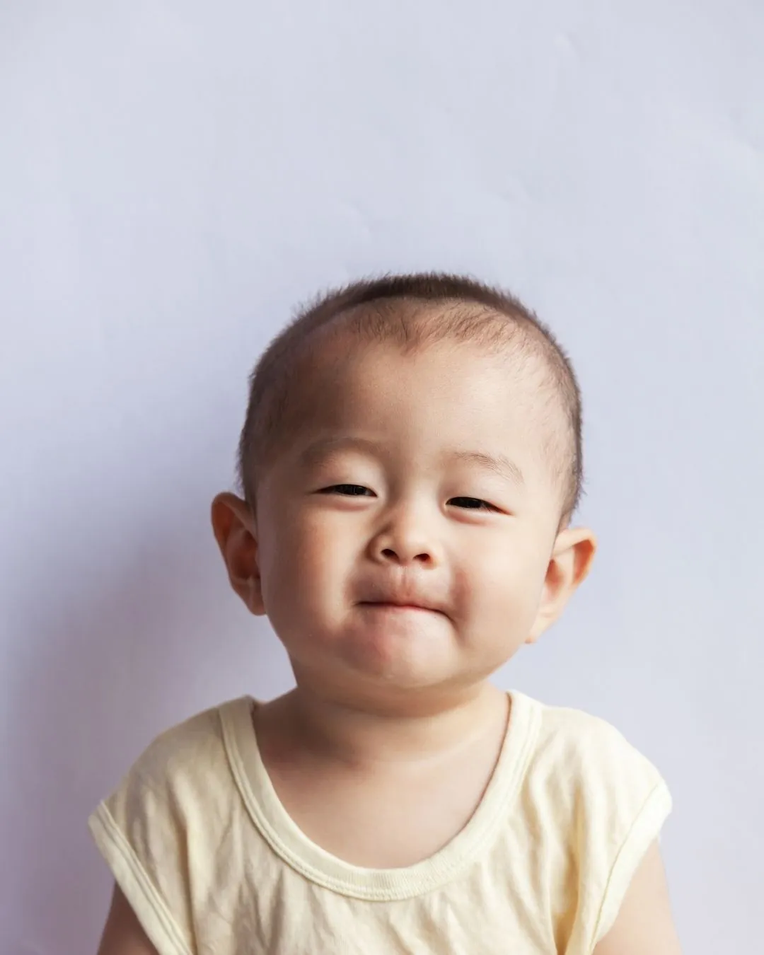 Young girl biting her fingernails, illustrating nail biting as a childhood oral habit that may affect teeth and bite.